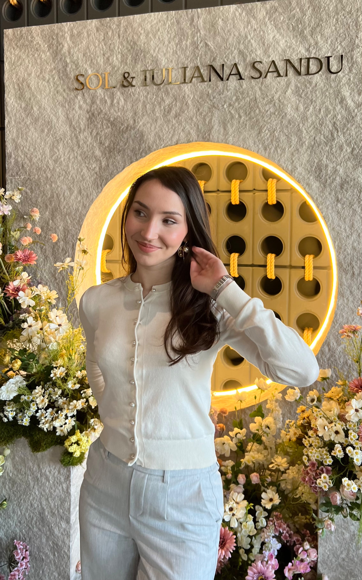 Alina at a branded event backdrop